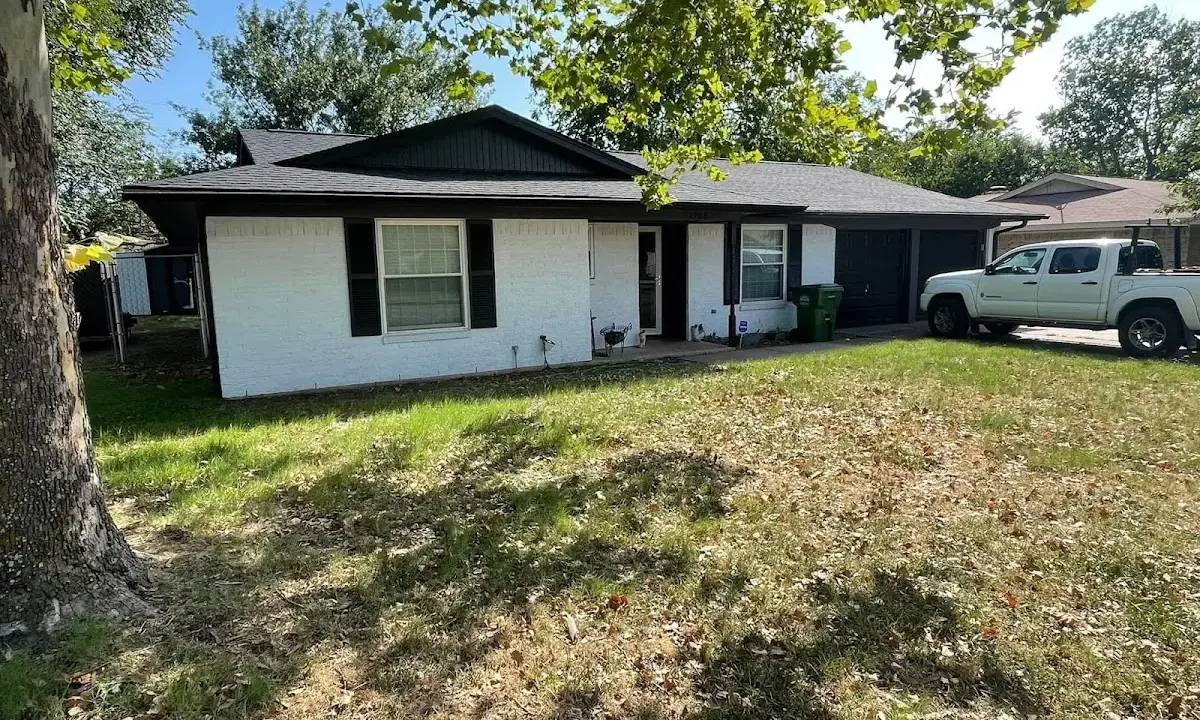 Professional roofing crew working on a residential roof in San Luis